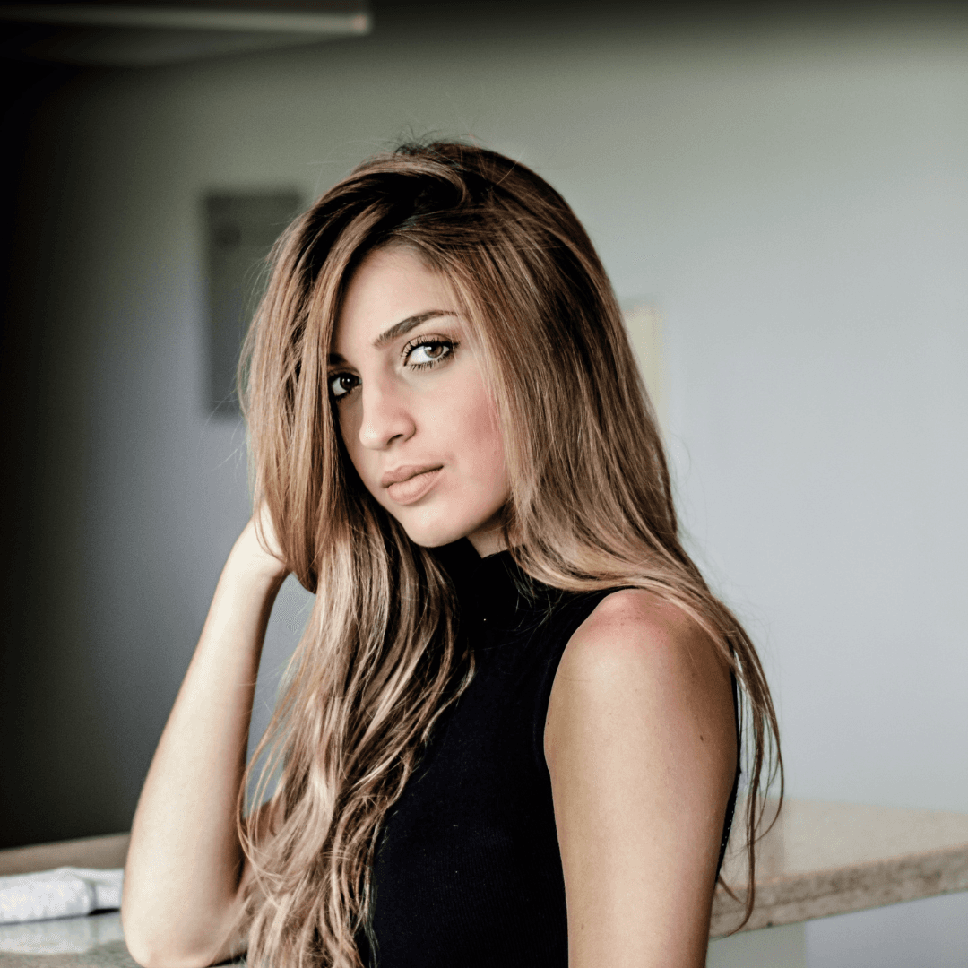 Woman with long, soft blonde highlighted hair, styled sleek and straight – showcasing professional highlights and foils by Merluza Hair & Beauty in Hall Green, Birmingham.